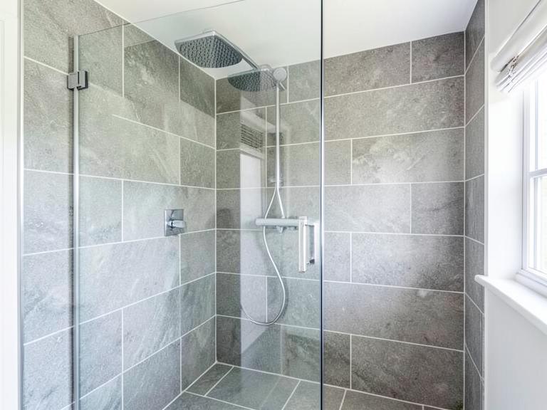 New walk-in shower with grey tiles