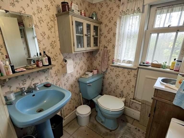Cluttered old family bathroom